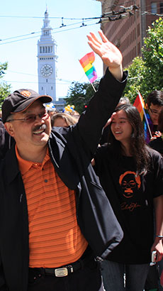 Mayor waving hands during pride parade